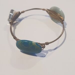 Gold bracelet with turquoise and clear stones.